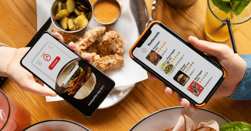 two hands holding mobile with food delivery platform operations app